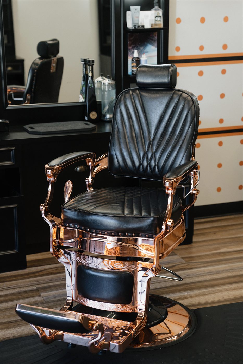 Antique rose-gold and black leather barber chair, up close