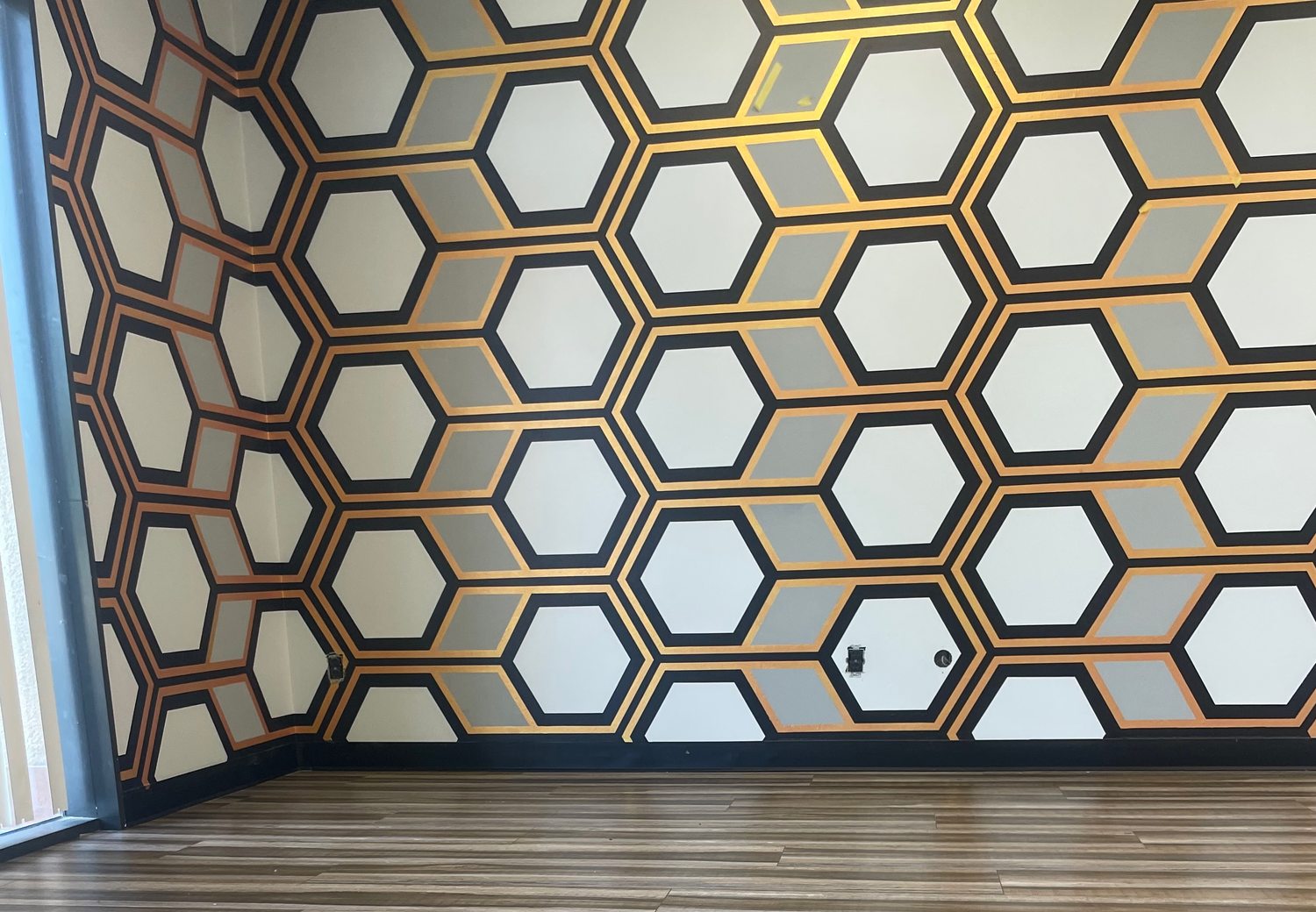 Honeycomb accent wall detail in copper and black