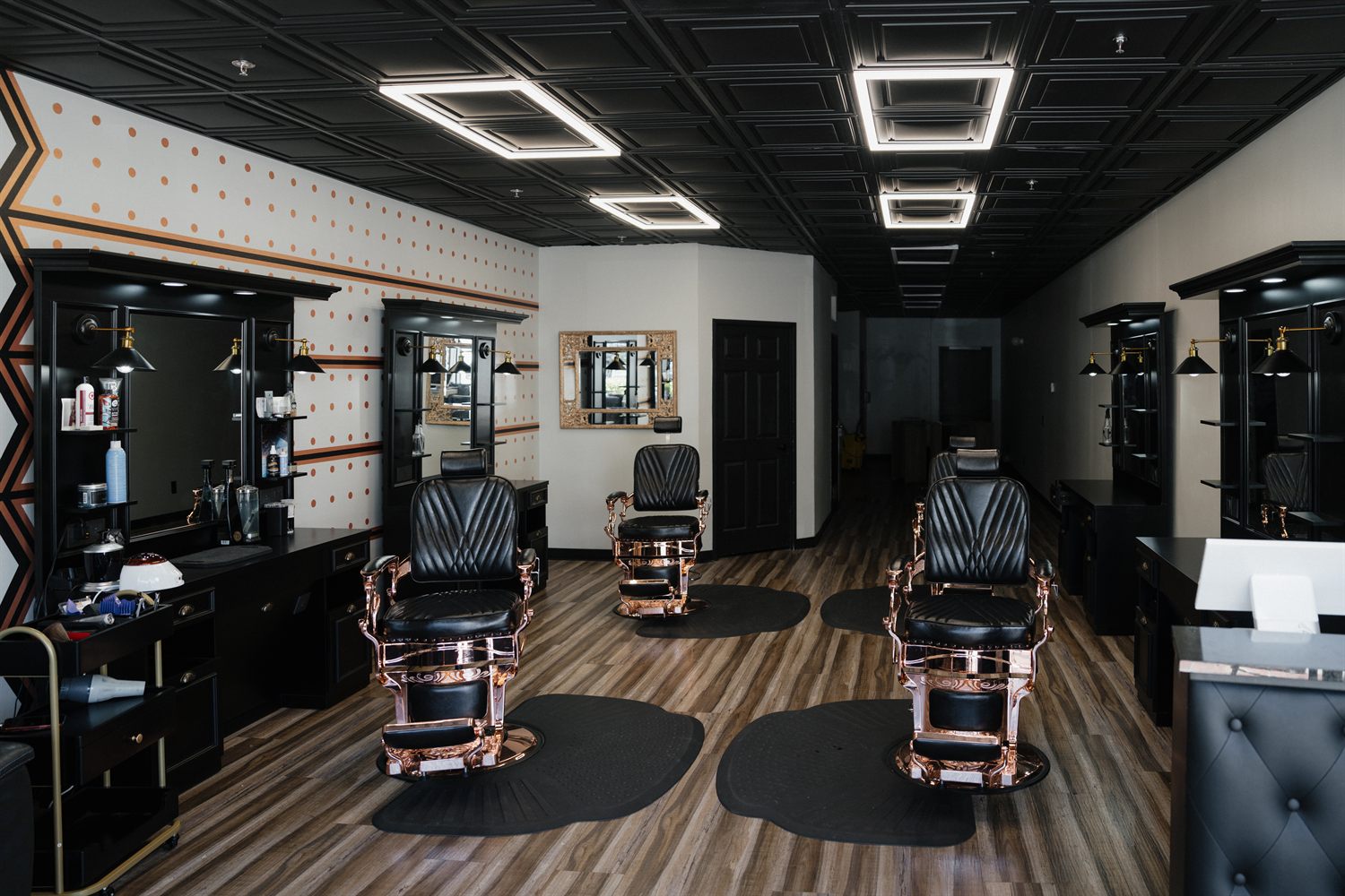 The barbering floor at Fathers Barber Salon with black mirror stations