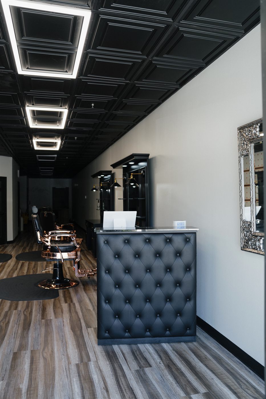 Tufted leather reception desk at Fathers Barber Salon