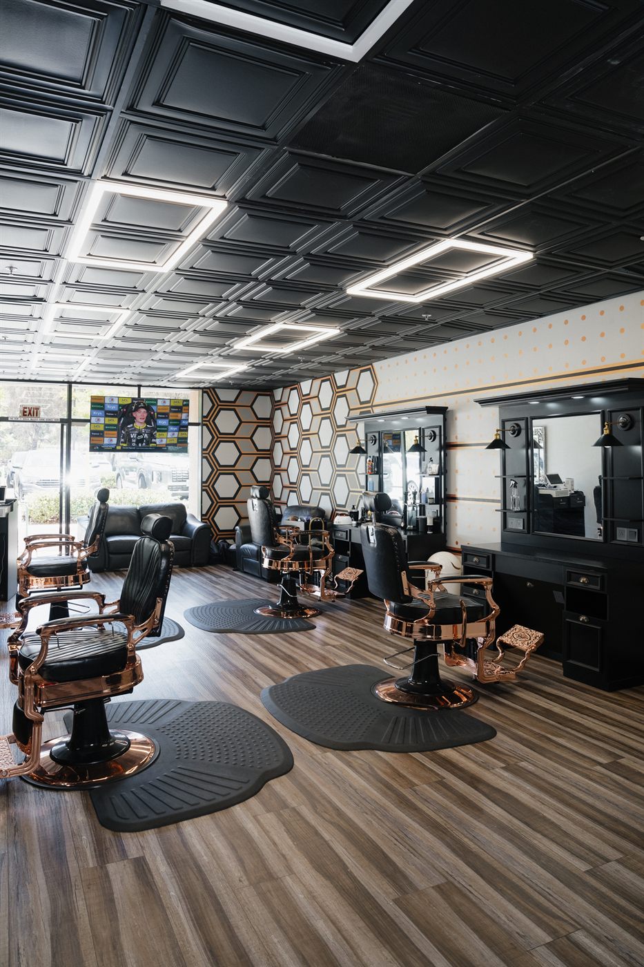 A line of barber stations under panel lighting